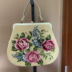 Vintage needlepoint handbag with
 Thumb release clutch closure.